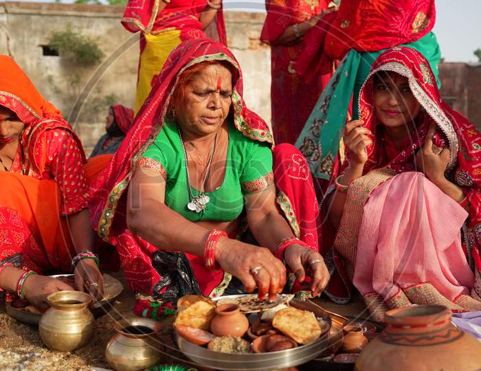 Hindu Cultured Females Praying Outdoors Wearing Ethnic Saree. They Are Worshipping Gods Of Hindu Mythology Idol.