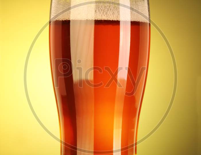 Full Beer Glass With Yellow Background
