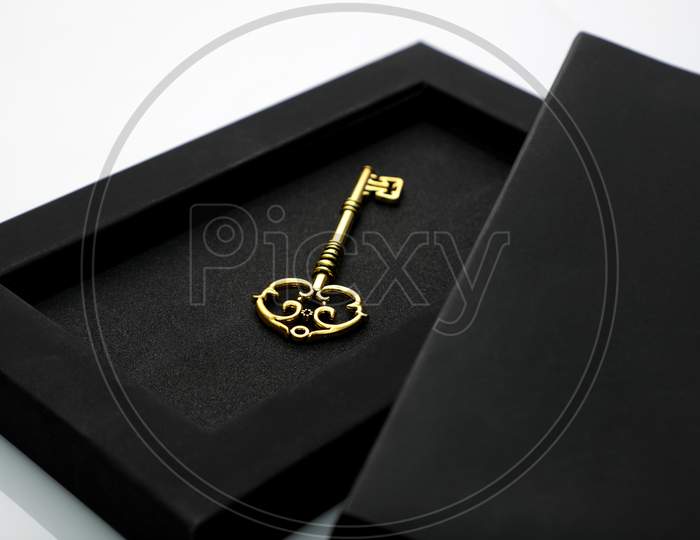 Antique Golden Key In A Black Box