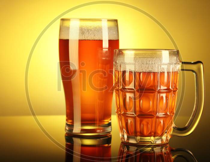 Two Beer Mug / Glass With Froth With Reflection