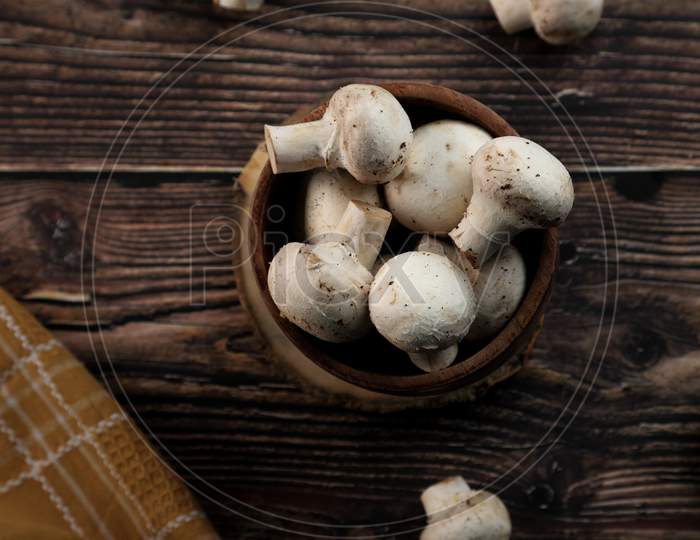 Fresh Organic Mushrooms In A Wooden Bowl