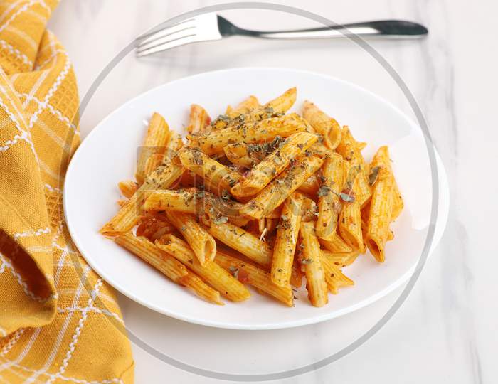 Food - Delicious Penne Pasta Plate With A Fork On White Marble Background