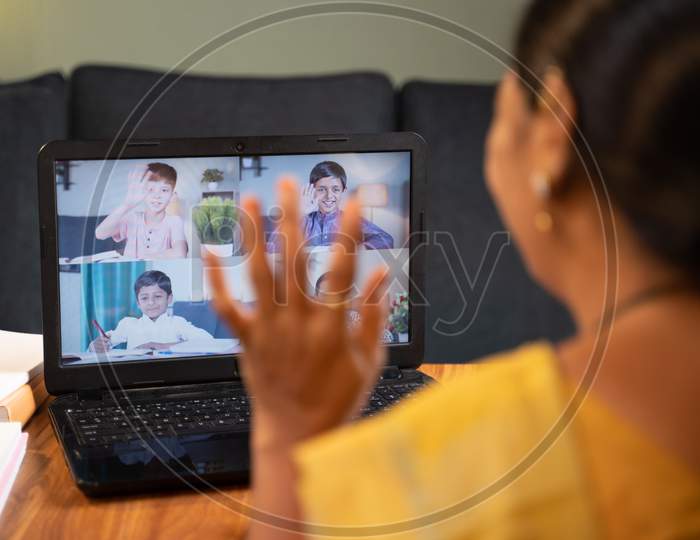 Shoulder Shot Of Teacher, Tutor Greeting Her Students During Online Class - Concep Of New Normal Virtual Teaching Or Education, Remote Learning, E-Teaching During Coronavirus Covid-19 Lockdown.