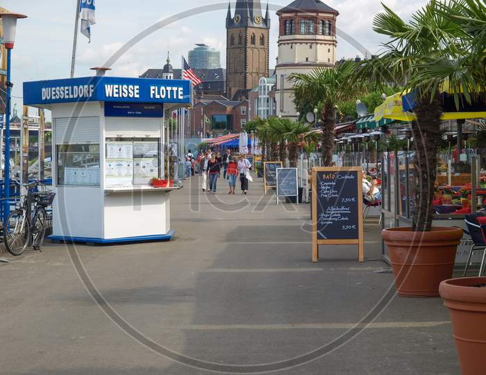 Duesseldorf, Germany - August 03, 2009: Tourists Walking By The Alfresco Bars In Summertime In The Old City Known As The Altstadt On The Riverside Of River Rhein