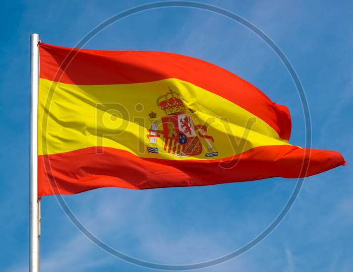 Spanish Flag Of Spain Over Blue Sky