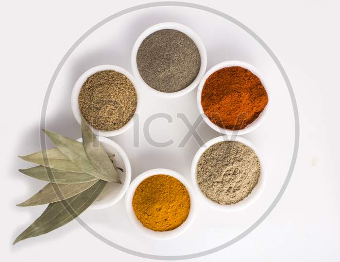 Various Spices In Ceramic Bowls Isolated On White Background. Stock Photo