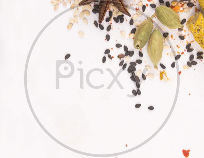 Spices: Turmeric, Chilly Powder And Cardamom On Ground With White Background Stock Photo