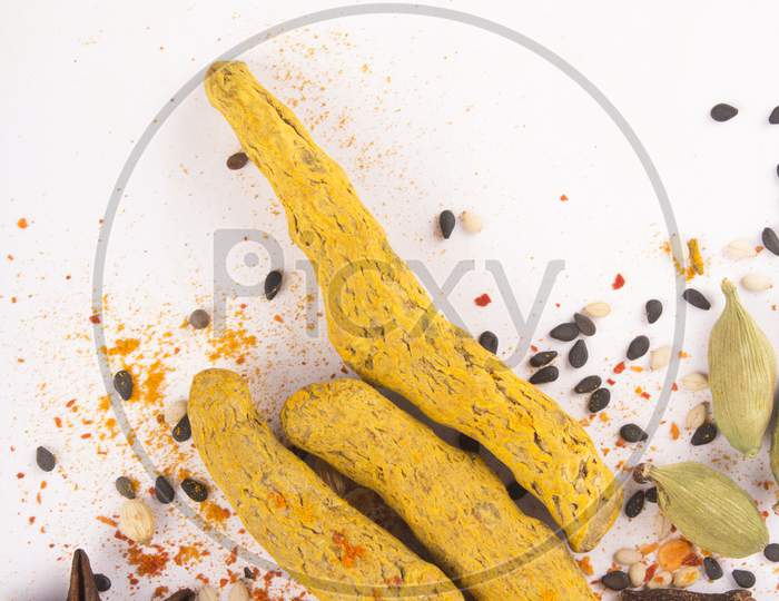 Spices: Turmeric, Chilly Powder, Cardamom And Cinnamon, Anise Stars On Ground With White Background, Top View Stock Photo