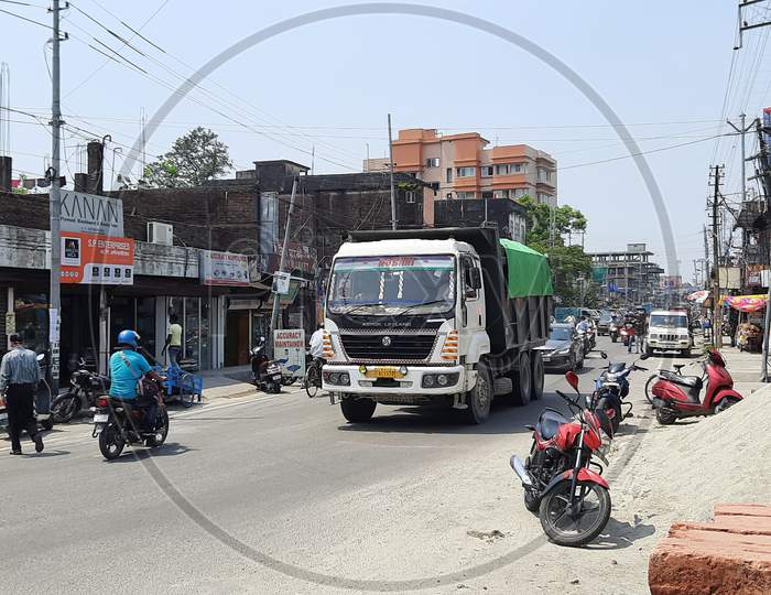 Vehicles are moving in Bongaigaon Township Highway near Paglasthan