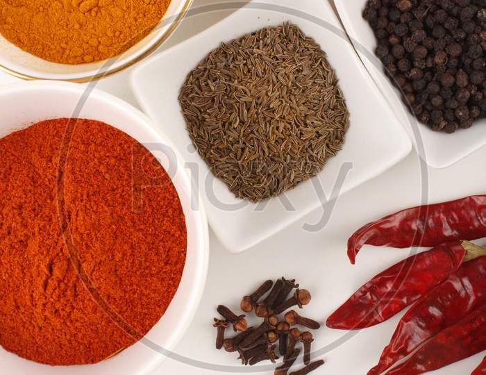 Spices: Turmeric, Pepper And Red Chilly, Etc,. Shot From Above On White Background Stock Photo