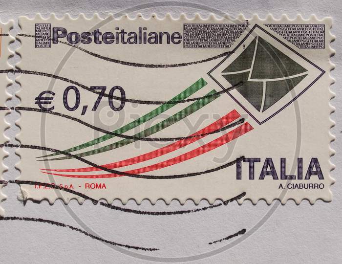 Turin, Italy - Circa October 2015: A Stamp Printed By Italy Shows A Letter Envelope With An Italian Flag