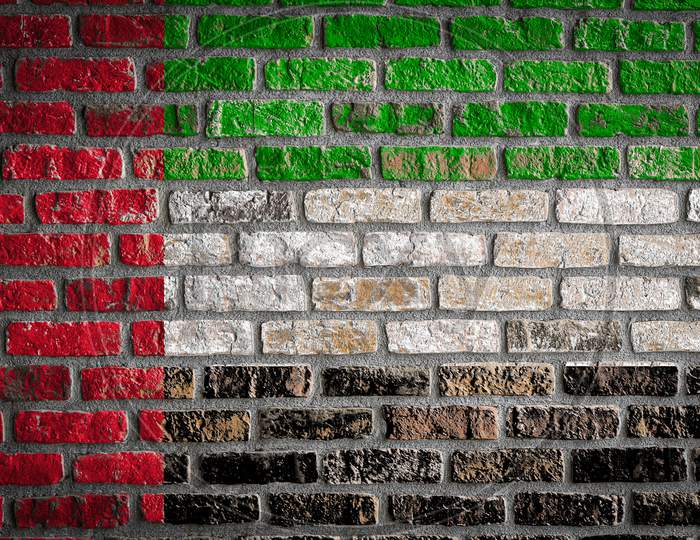 National Flag Of United Arab Emirates
 Depicting In Paint Colors On An Old Brick Wall. Flag  Banner On Brick Wall Background.