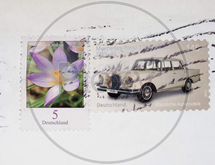 Berlin, Germany - July 31, 2015: Stamps Printed By Germany Show A Krokus Flower And A Classic Mercedez Benz Car