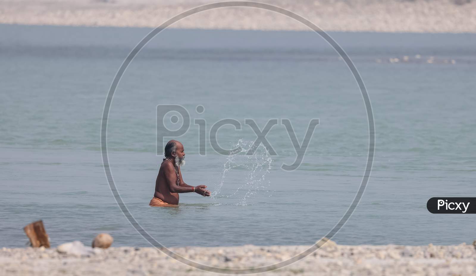 Indian Sadhu taking holy dip in river ganges during kumbh mela