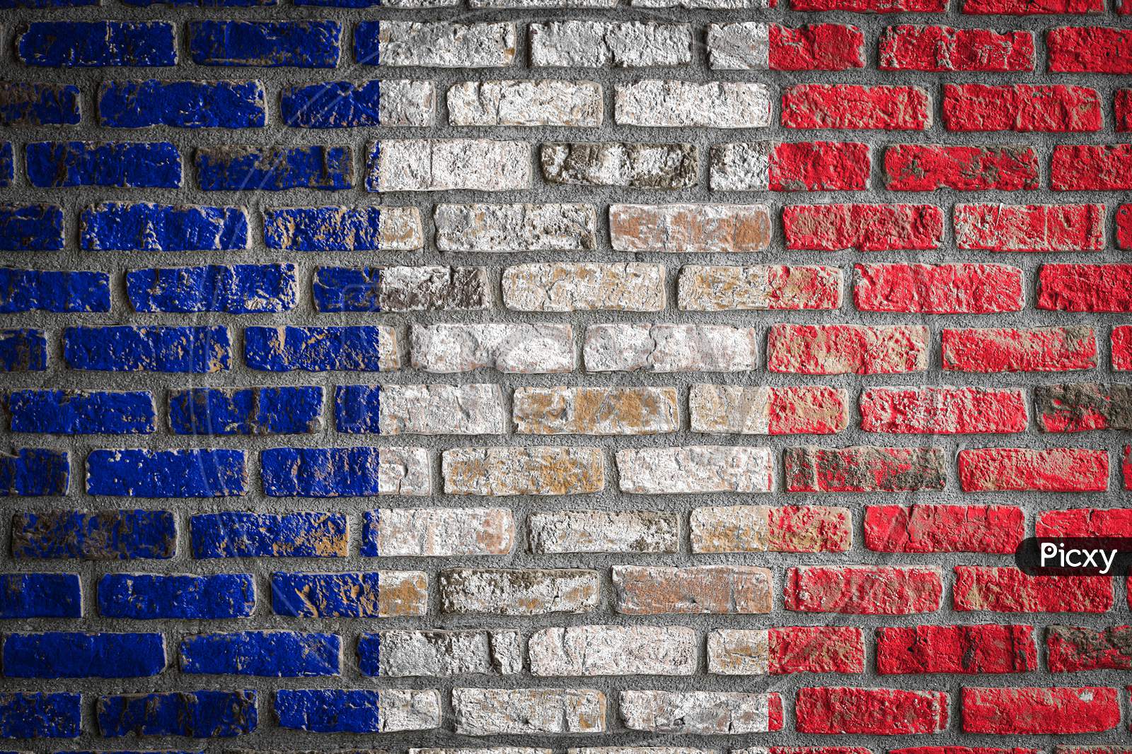 National Flag Of France Depicting In Paint Colors On An Old Brick Wall. Flag  Banner On Brick Wall Background.