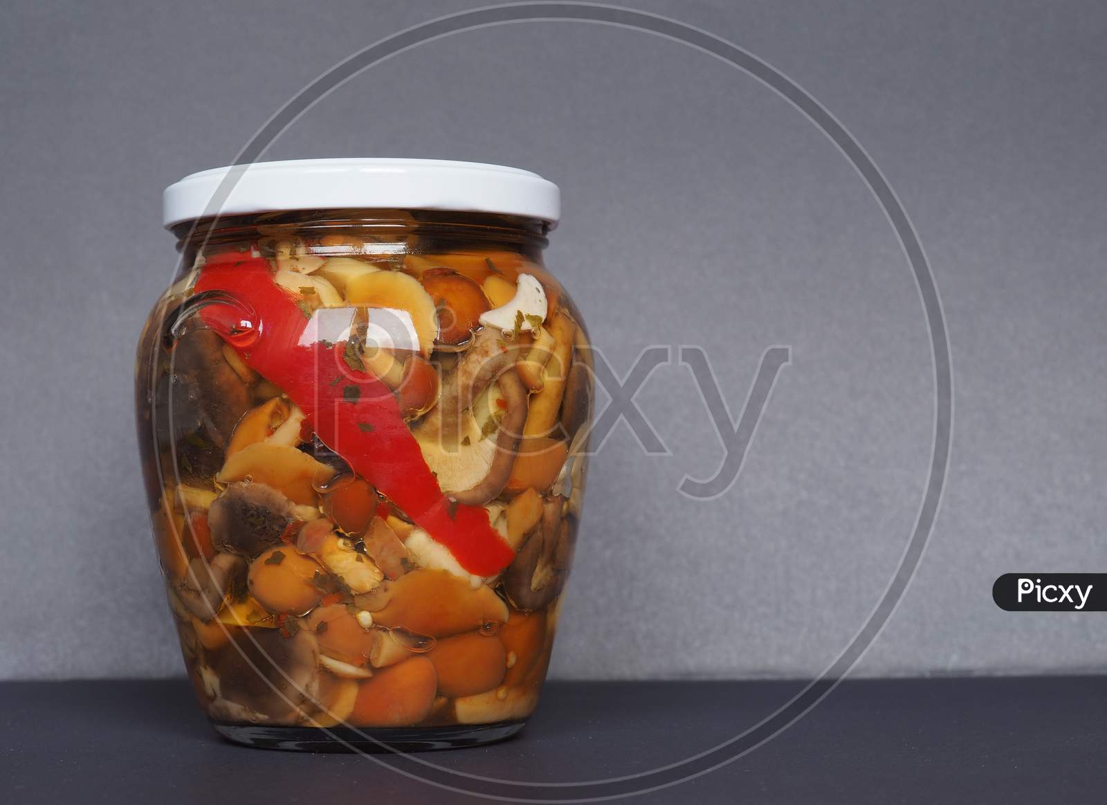 Mixed Champignons And Porcini Mushrooms In Jar
