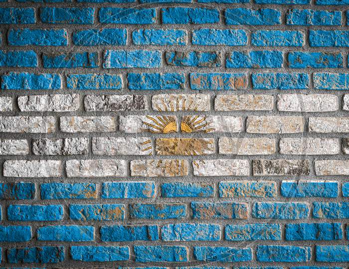 National Flag Of Argentina
 Depicting In Paint Colors On An Old Brick Wall. Flag  Banner On Brick Wall Background.