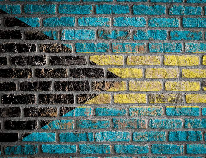National Flag Of Bahamas Depicting In Paint Colors On An Old Brick Wall. Flag  Banner On Brick Wall Background.