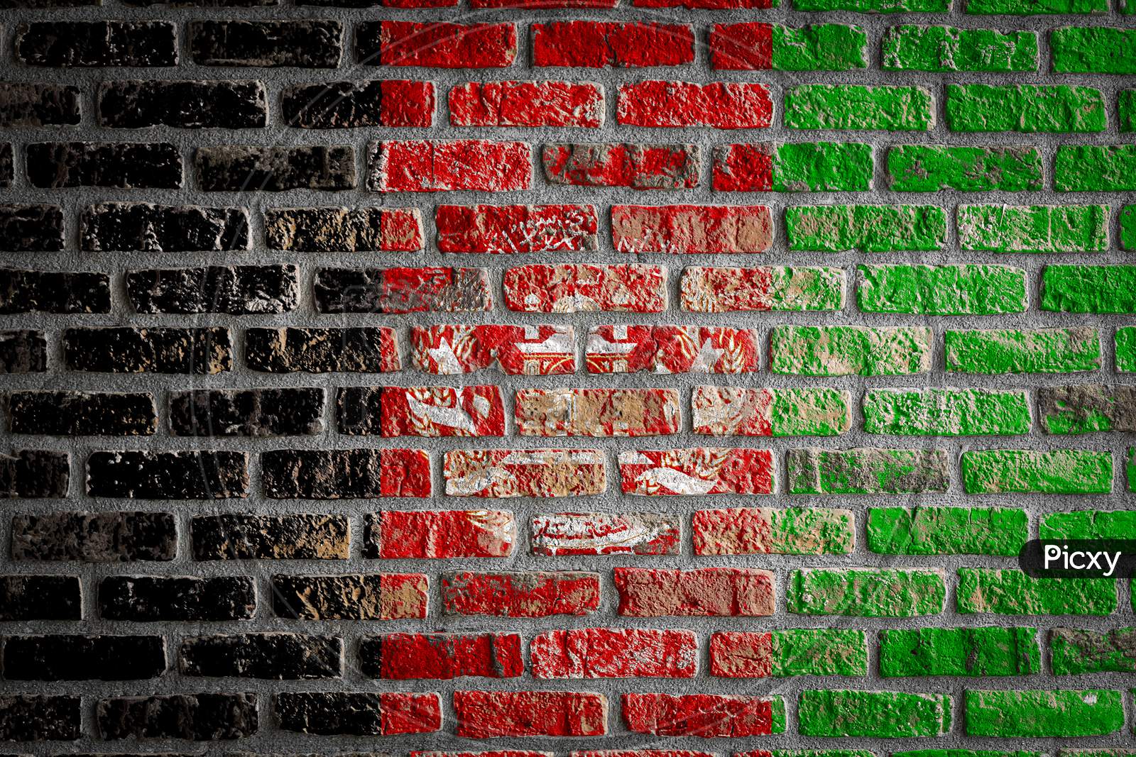National Flag Of Afghanistan Depicting In Paint Colors On An Old Brick Wall. Flag  Banner On Brick Wall Background.