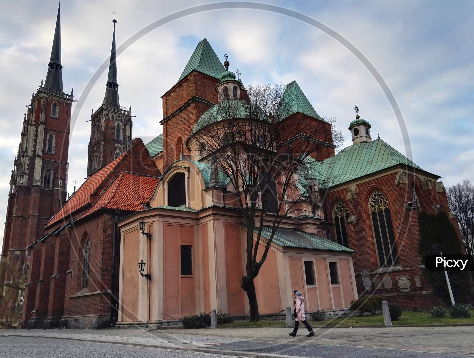 Wroclaw, Poland - December 29, 2017: Wide Angle Shot Of People Walking Against Famous Landmark Cathedral Of St. John The Baptist Church.