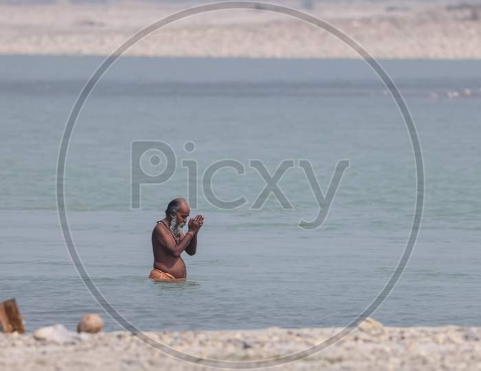 Indian Sadhu taking holy dip in river ganges during kumbh mela