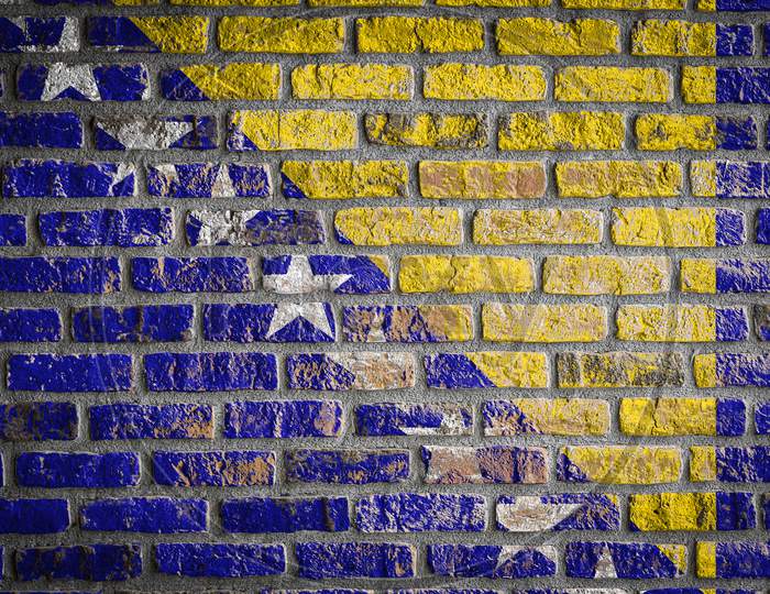 National Flag Of Bosnia Herzegovina Depicting In Paint Colors On An Old Brick Wall. Flag  Banner On Brick Wall Background.
