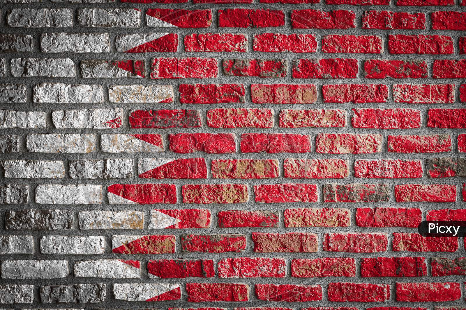 National Flag Of Bahrain Depicting In Paint Colors On An Old Brick Wall. Flag  Banner On Brick Wall Background.