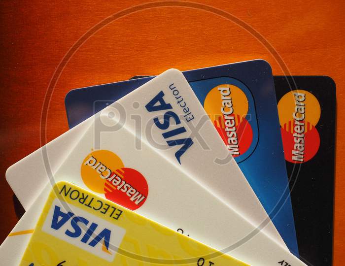 London, Uk - December 25, 2015: Mastercard And Visa Credit Cards On Wooden Table