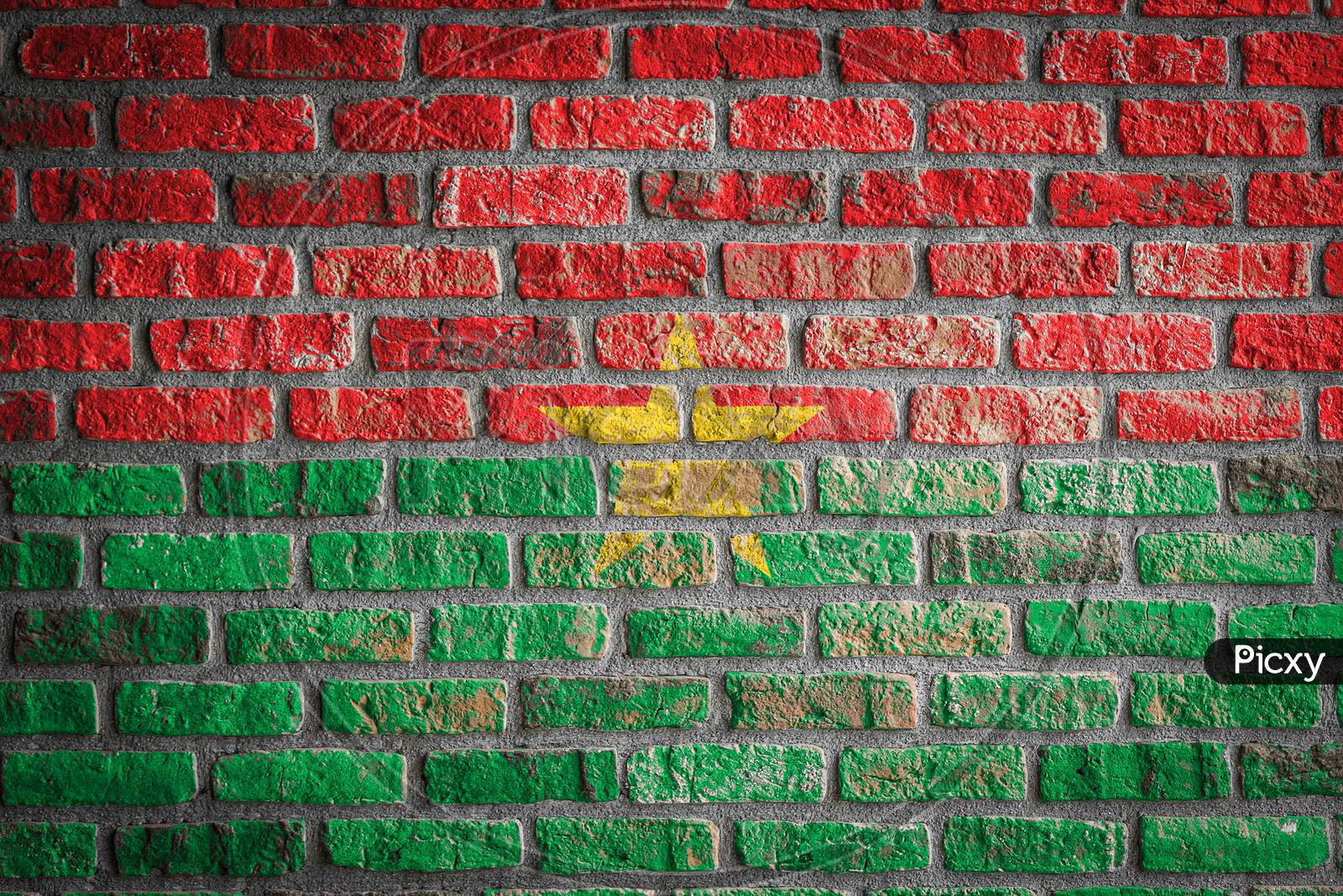 National Flag Of Burkino Faso
 Depicting In Paint Colors On An Old Brick Wall. Flag  Banner On Brick Wall Background.