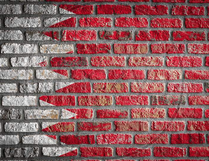 National Flag Of Bahrain Depicting In Paint Colors On An Old Brick Wall. Flag  Banner On Brick Wall Background.