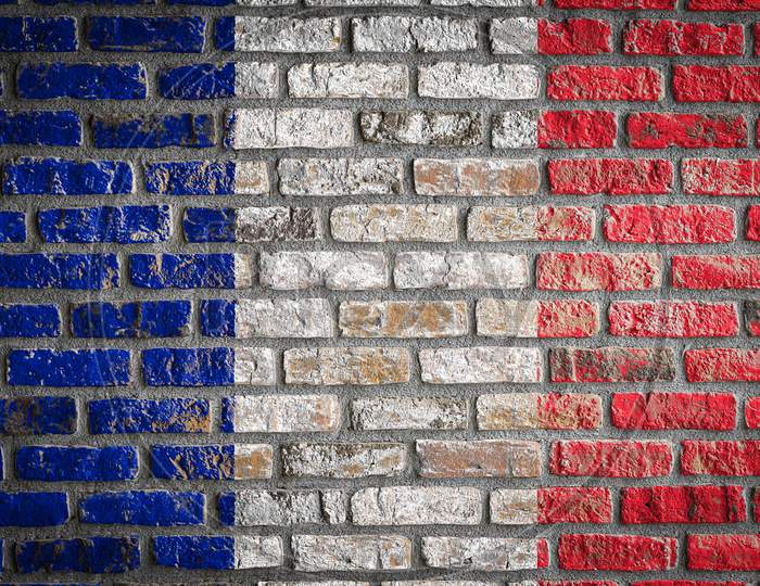 National Flag Of France Depicting In Paint Colors On An Old Brick Wall. Flag  Banner On Brick Wall Background.