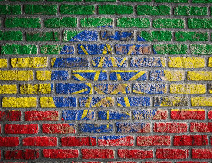 National Flag Of Ethiopia Depicting In Paint Colors On An Old Brick Wall. Flag  Banner On Brick Wall Background.