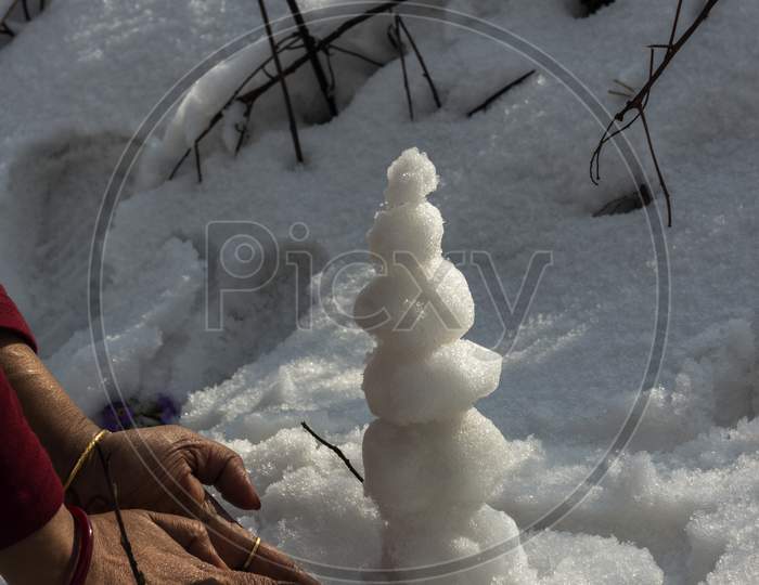 Tourist Made Small Snow Man With Ice While After Snowfall.