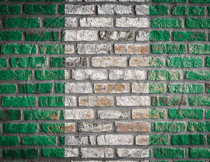 National Flag Of Nigeria
 Depicting In Paint Colors On An Old Brick Wall. Flag  Banner On Brick Wall Background.