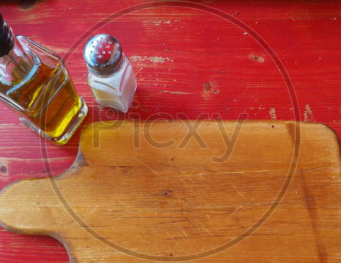 image-of-wooden-cutting-board-with-olive-oil-and-salt-mf797784-picxy