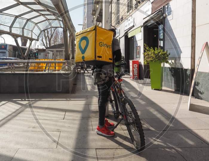 Turin, Italy - Circa February 2019: Glovo Courier Delivering Food And Products