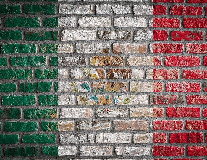 National Flag Of Mexico
 Depicting In Paint Colors On An Old Brick Wall. Flag  Banner On Brick Wall Background.