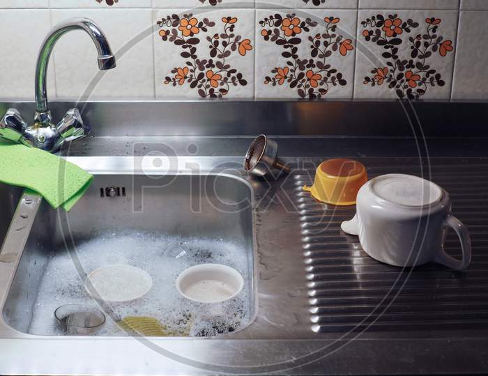 Hand Dish Washing In Kitchen Sink With Detergent Foam