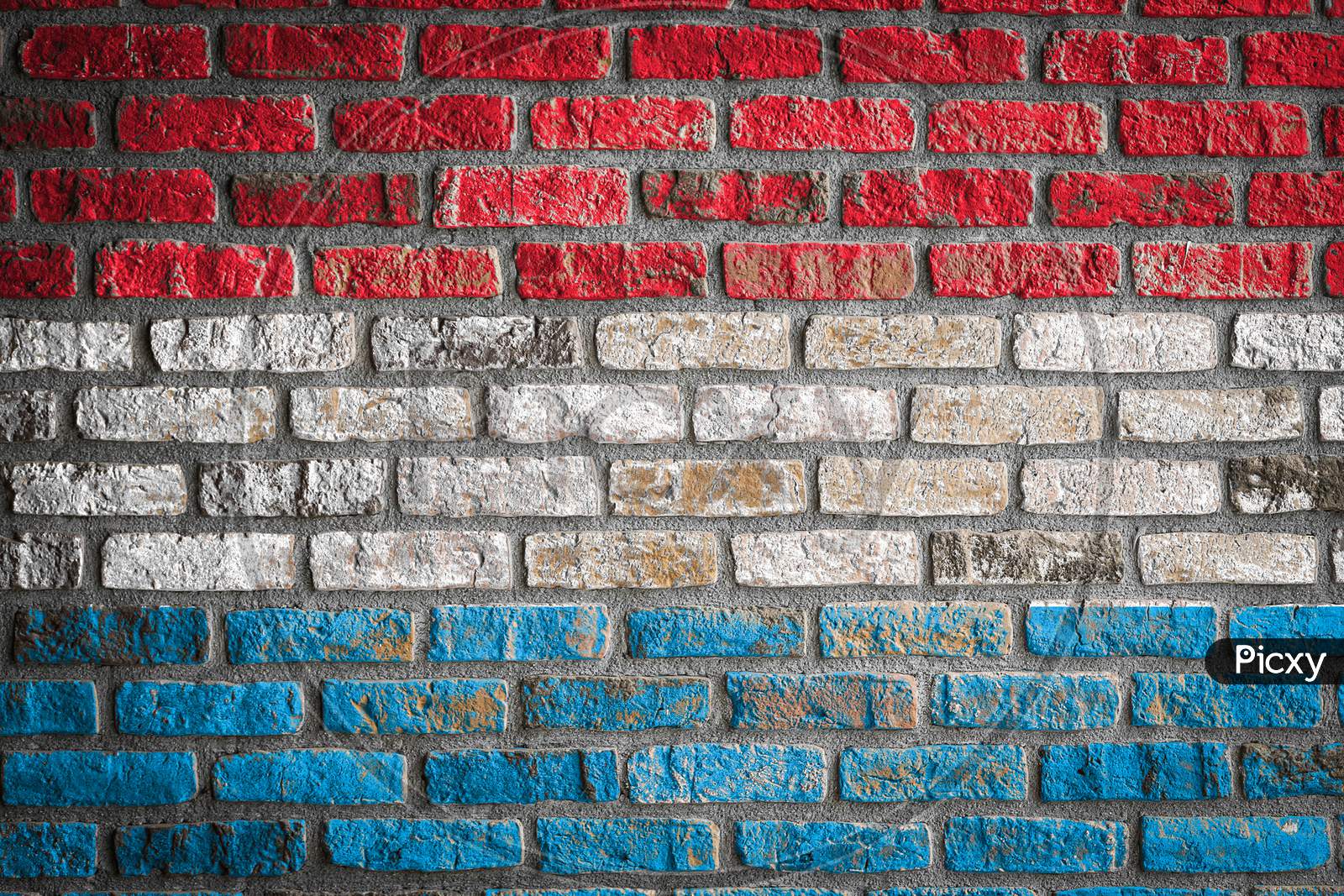 National Flag Of Luxembourg Depicting In Paint Colors On An Old Brick Wall. Flag  Banner On Brick Wall Background.