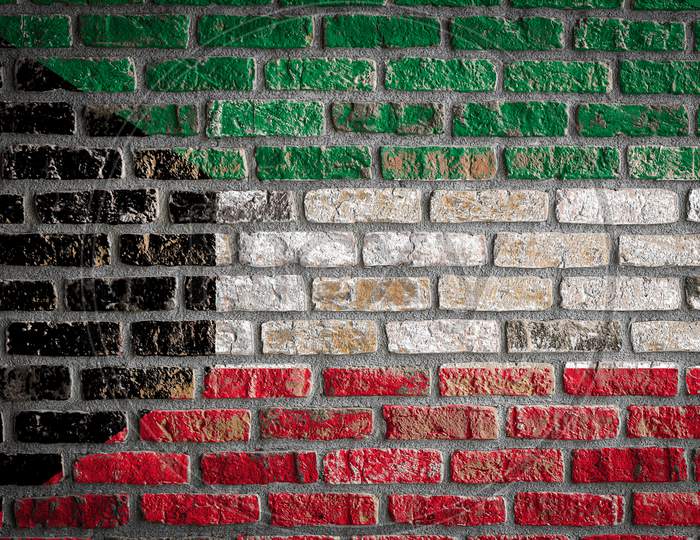 National Flag Of Kuwait
 Depicting In Paint Colors On An Old Brick Wall. Flag  Banner On Brick Wall Background.