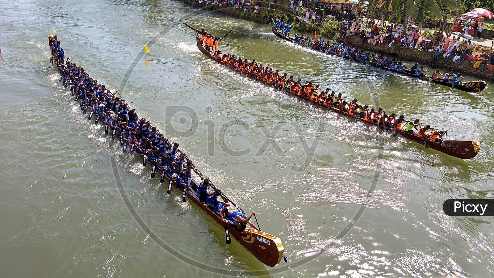 Three boats(type- veppu vallam) are heading towards finishing line in Kottayam boat race, India