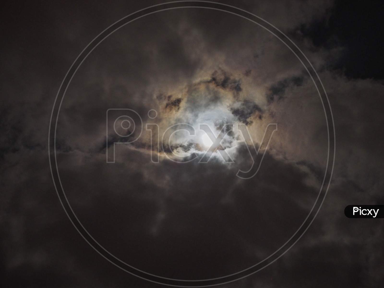 Moon In Dark Cloudy Night Sky