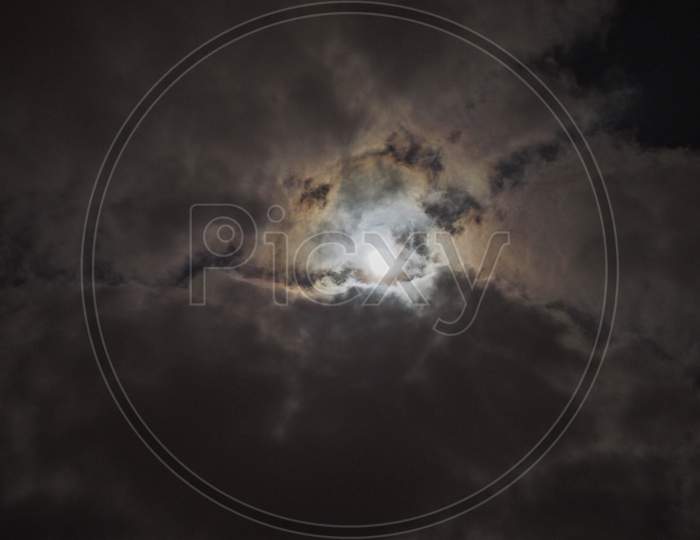 Moon In Dark Cloudy Night Sky