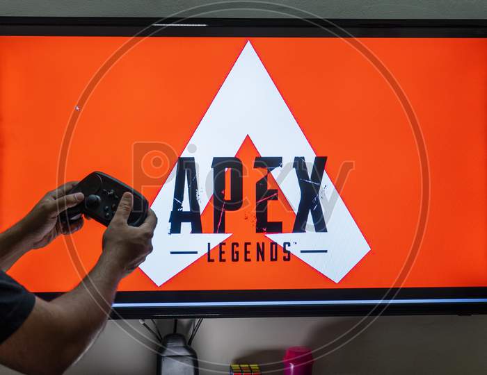 Man Holding Steam Controller In Front Of A Screen Loading Apex Legends A Massively Online Multiplayer Shooter Game With Millions Of Followers