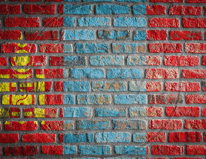 National Flag Of Mongolia Depicting In Paint Colors On An Old Brick Wall. Flag  Banner On Brick Wall Background.
