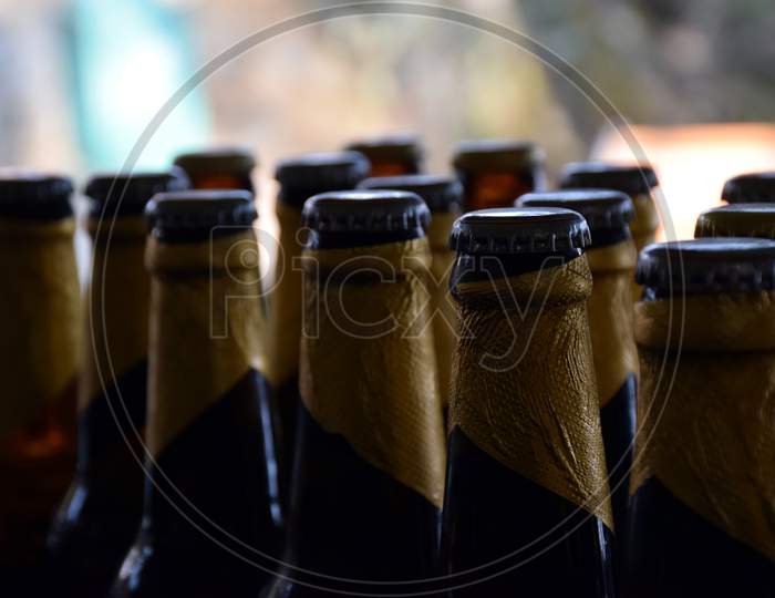 Close Up Picture Of Glass Bottle And Iron Cap On It. Background Blur