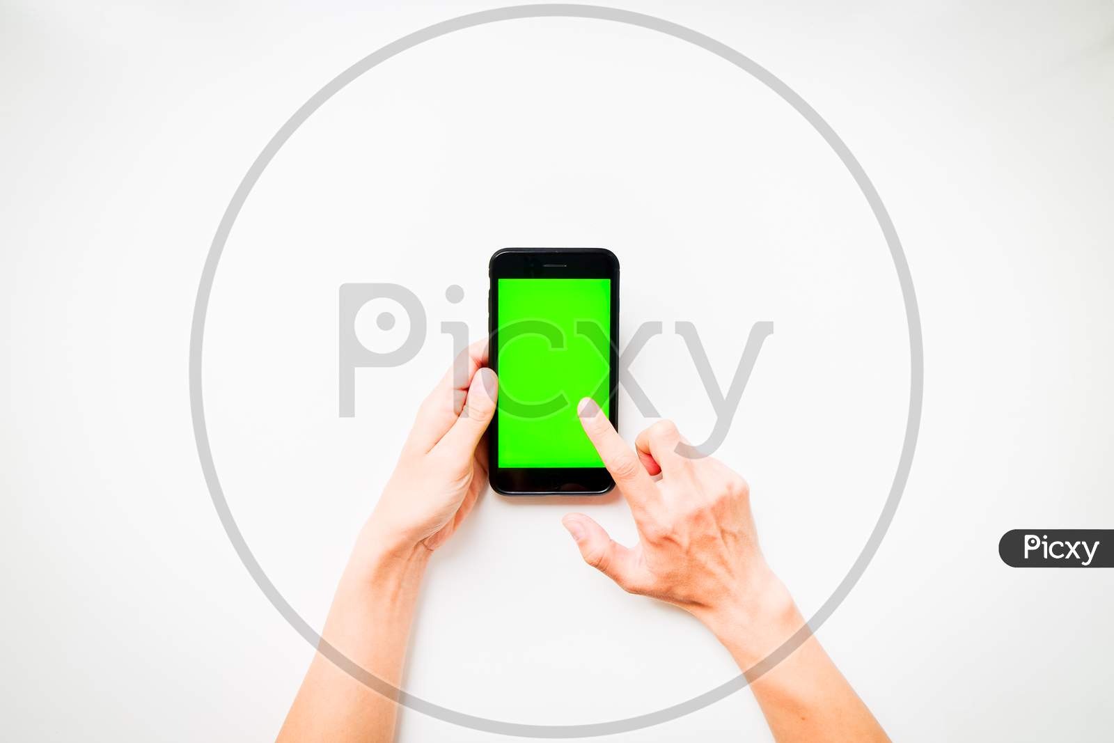 Females Hand Shows Mobile Smartphone With Green Screen In Vertical Position Isolated On White Background With Finger Tap Screen. Mock Up Mobile Technology Ad Concept.