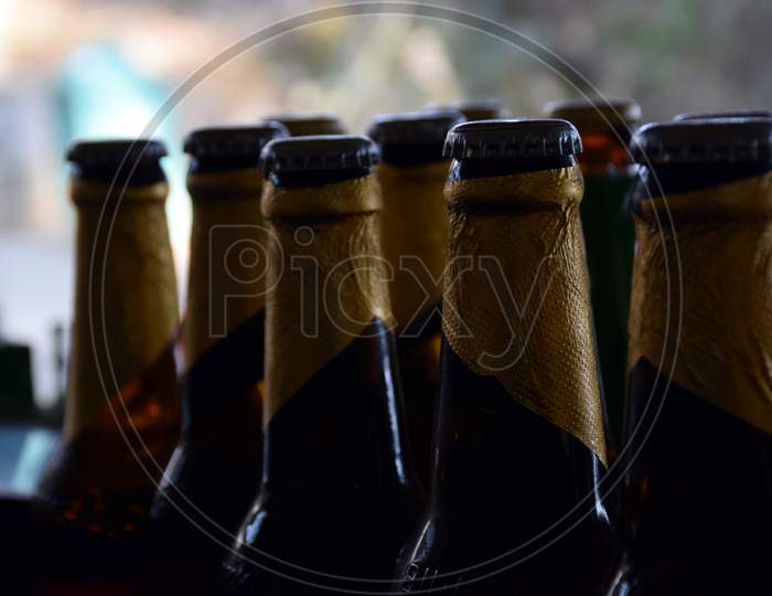 Close Up Picture Of Glass Bottle And Iron Cap On It. Background Blur