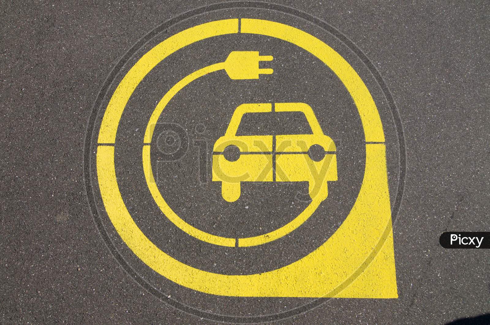 Yellow Electric Vehicle Charging Station Symbol On Asphalt
