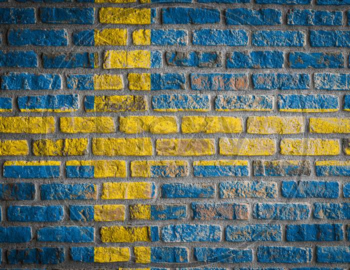 National Flag Of Sweden
 Depicting In Paint Colors On An Old Brick Wall. Flag  Banner On Brick Wall Background.